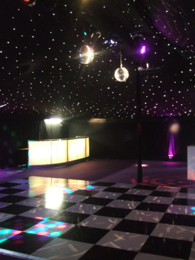 Black and white dance floor and illuminated bar